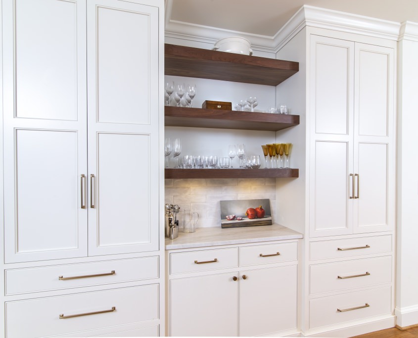 White kitchen cabinets with walnut floating shelves